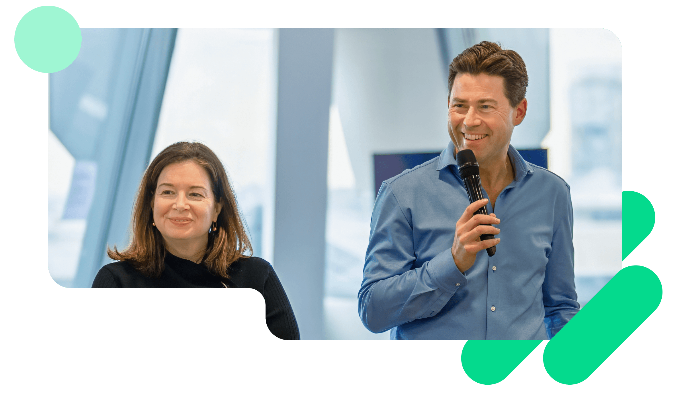 A photo of Adrian Blair, CEO, and Alicia Skubick, Chief Customer Officer, presenting in a Trustpilot company meeting